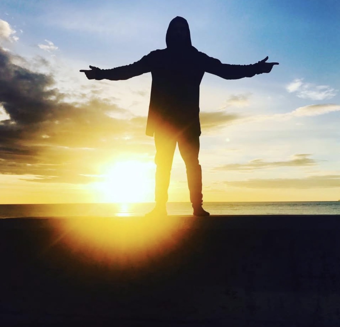 Silhouette at sunset by the sea